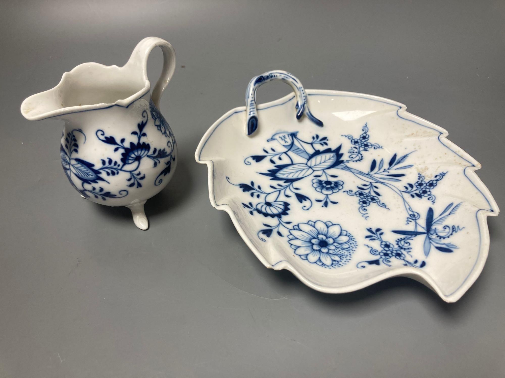 A Meissen blue and white onion pattern jug and a similar leaf shaped pickle dish (2)